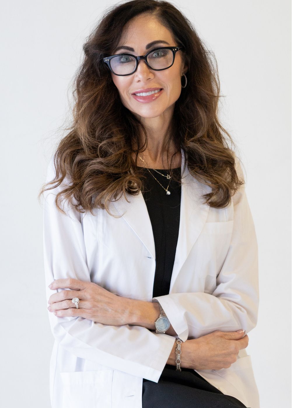 Female doctor in white coat and glasses.