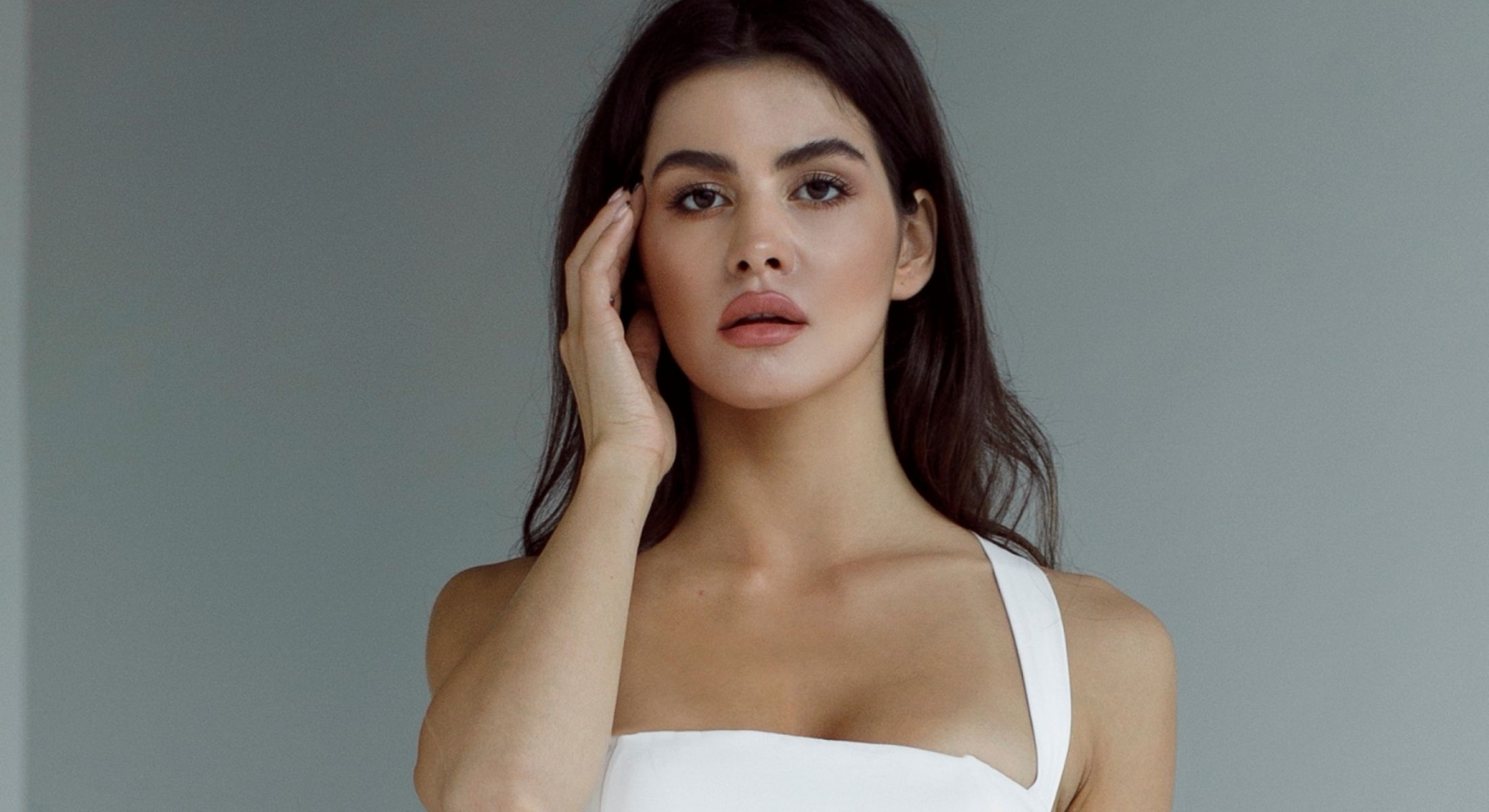 Woman in light blue shirt, serene expression